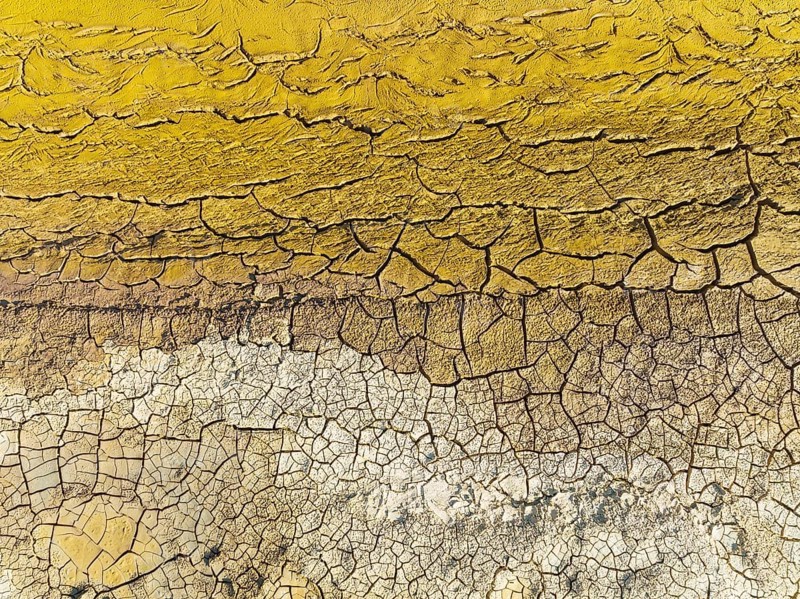 Mineral-rich cracked earth at the bank of the Rio Tinto (Red river), aerial view, drone shot, Huelva province, Andalusia, Spain, Europe