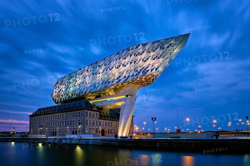 ANTWERP, BELGIUM, MAY 27, 2018: Port authority house (Porthuis) designed by famous Zaha Hadid Architects which was her last project illuminated in the night