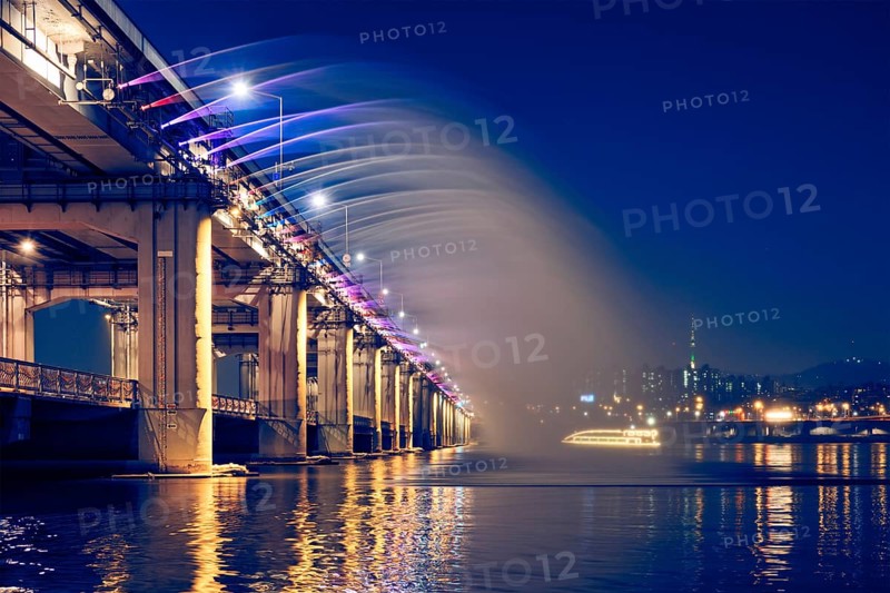 SEOUL, SOUTH KOREA, APRIL 7, 2017: Banpo Bridge Rainbow Fountain tourist landmark on Han river illuminated at night, Seoul, South Korea, Asia