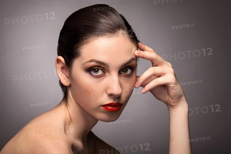 Beauty fashion girl. Portrait of beautiful young woman with fresh clean skin on grey background
