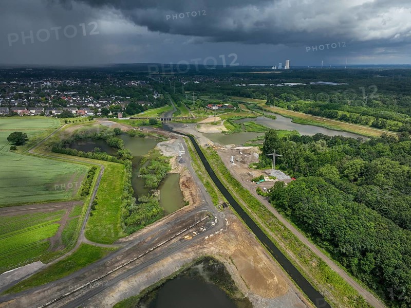 Dortmund / Castrop-Rauxel, North Rhine-Westphalia, Germany, river renaturalisation, renaturation of the Emscher, flood retention basin HRB Mengede. A new floodplain landscape is being created at the Emscher-Auen farm, expanding the area for flood protection during heavy rainfall and for biodiversity. The Emscher, which is currently straightened, will be given curves again and can meander through its new floodplain. Following the construction of a parallel sewer, the Emscher has been completely free of wastewater since 2022. The river was previously an open, above-ground mixed water channel with rainwater and wastewater. At the back right, the Uniper coal-fired power plant Datteln 4 power station, Europe