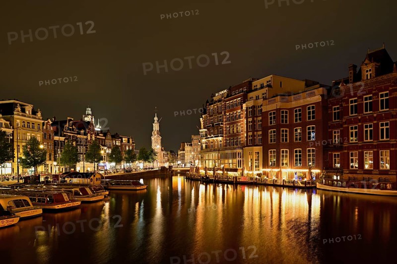 Historic buildings and mint tower illuminated at night, Singelgracht, Amsterdam, North Holland, Netherlands