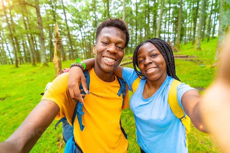 African friends during selfie moment while hiking in the forest