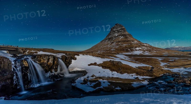 Long exposure panorama of the picturesque Kirkjufell mountain at night in winter in Iceland