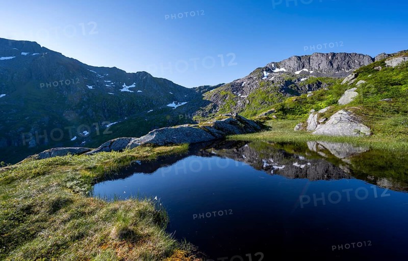 Mountains reflected in a lake, hike to the summit of Rundfjellet, Svolvaer, Nordland, Norway, Europe