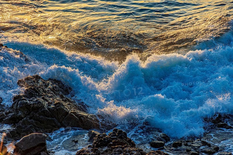 Waves foam over rocks during sunset in Salvador, Bahia, Salvador, Bahia, Brazil, South America