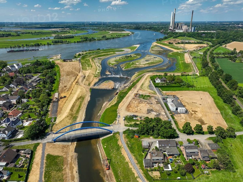 Dinslaken, Voerde, North Rhine-Westphalia, Germany, Renaturalisation of the Emscher. New Emscher estuary into the Rhine. Flood protection through land expansion. The decommissioned STEAG coal-fired power station in Voerde in the background. The mouth of the Emscher into the Rhine was moved from Dinslaken to Voerde, almost 500 metres to the north. Fish can now swim barrier-free up the new Emscher from the Rhine through a newly created floodplain area. Following the construction of a parallel sewer, the Emscher has been completely free of sewage since January 2022. The river was previously an open, above-ground combined sewer with rainwater and wastewater, Europe