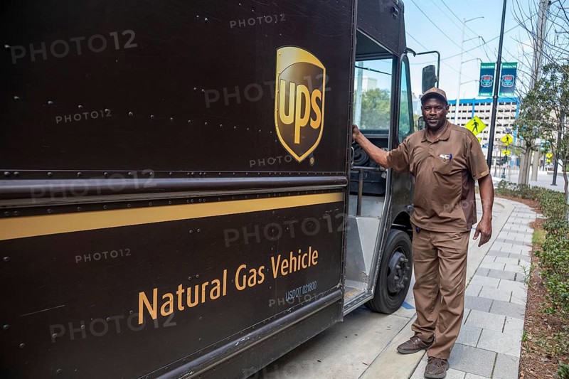 New Orleans, Louisiana - A United Parcel Service driver and his natural gas powered 'package car' at the New Orleans Convention Center