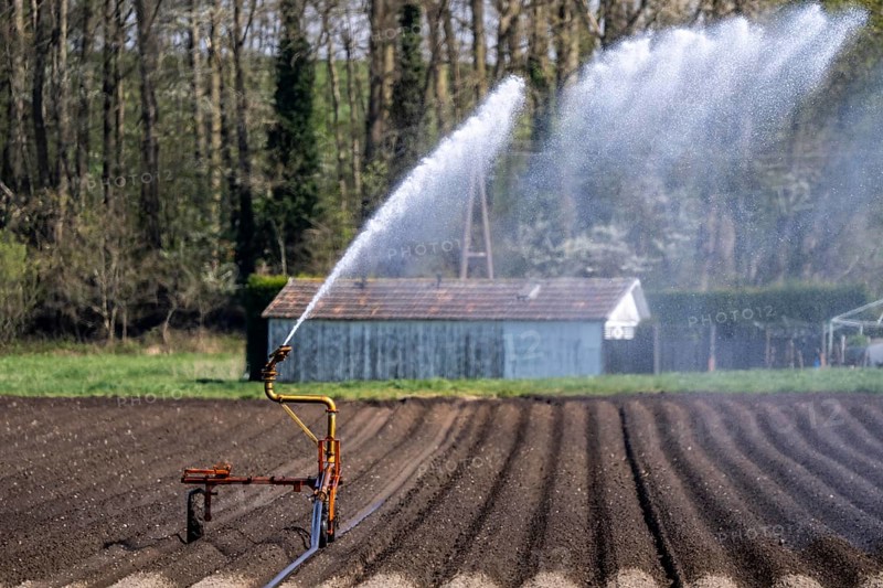 Artificial irrigation of a potato field in April, with a sprinkler system, long drought in spring makes this necessary, for the total of 7.5 hectares 3 full days are needed to get the necessary moisture for the freshly sown potato plants, south of Straelen, Lower Rhine, North Rhine-Westphalia, Germany, Europe