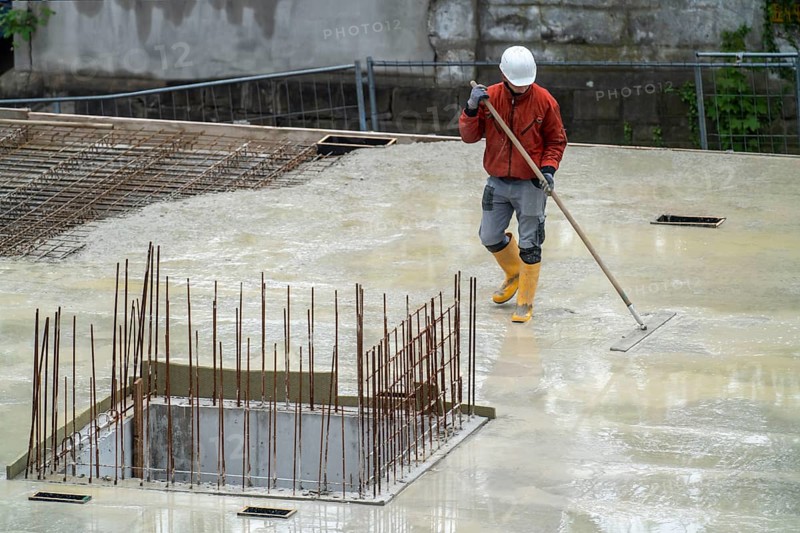 Construction site, concreting, the floor slab of a building is concreted, the fresh concrete is levelled