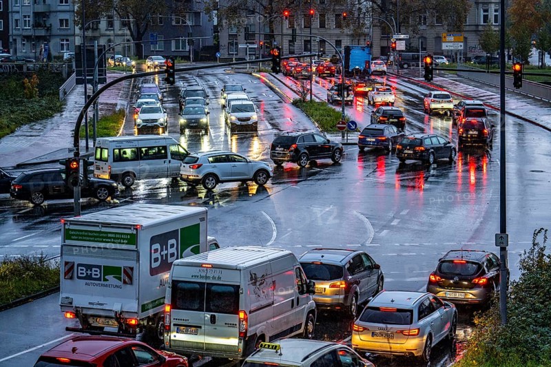 Rainy weather, road traffic, intersection, lights of vehicles on a wet road, traffic lights, tail lights, headlights, symbolic image
