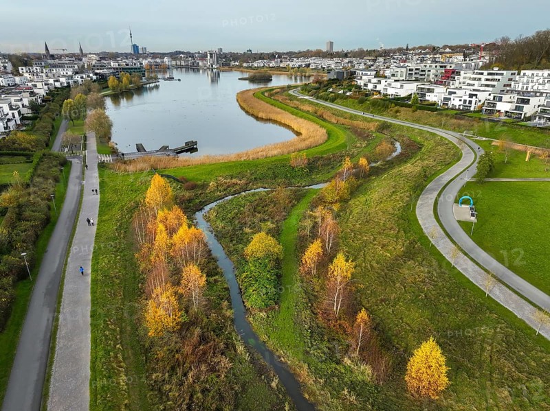 Dortmund, North Rhine-Westphalia, Germany, Phoenix Lake, front of the renaturalised Emscher. The river has been transformed into a near-natural body of water, flood protection and biodiversity through newly designed floodplains. A former industrial wasteland of 99 hectares was transformed into residential, work and leisure areas and 24 hectares of lake surface. In the event of heavy rainfall, the lake acts as a rainwater retention basin. Following the construction of a parallel sewer, the Emscher is now free of wastewater, having previously been an open, above-ground wastewater sewer, combined sewer with surface water and wastewater. The Phoenix Lake, a showcase project for structural change, is an artificial lake on the site of the former Phönix Ost steelworks in Dortmund's Hörde district, Europe