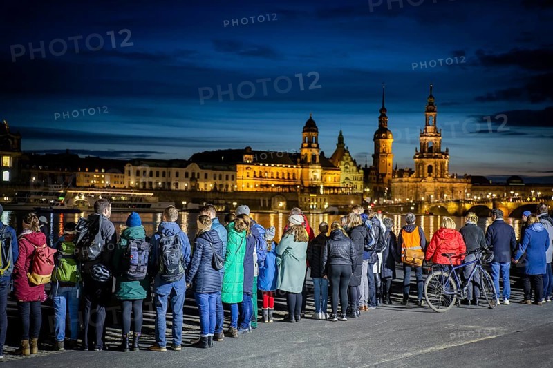 On 13 and 14 February 1945, Dresden was heavily destroyed in three Allied bombing raids. Every year, the people of Dresden commemorate this event at various events. A long human chain symbolised the protection of the city centre. Here looking from the Königsufer across the Elbe to the Old Town, Dresden, Saxony, Germany, Europe