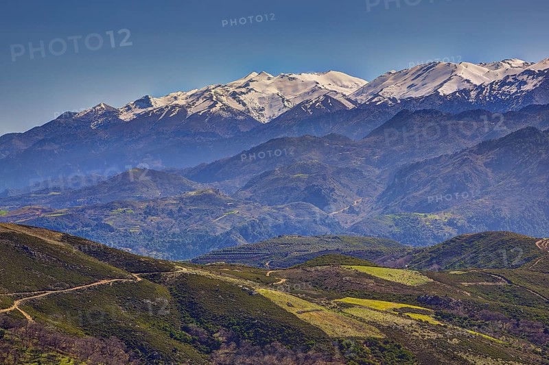 Mountain landscape with snow-covered peaks, green hills and windy paths, Lefka Ori, White Mountains, mountain massif, west, Crete, Greece, Europe
