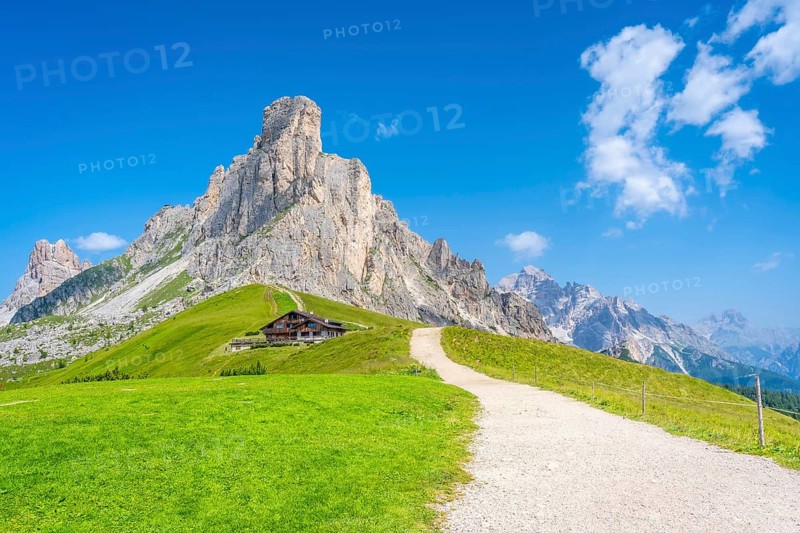 Scenic view of idyllic valley with hiking trail leading to refuge at the foot of majestic nuvolau mountain range in the heart of italian dolomites