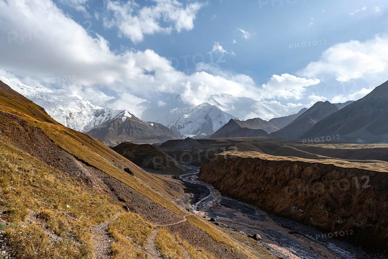 Valley with river Achik Tash between high mountains, mountain landscape with glaciated peak Pik Lenin, Trans Alay Mountains, Pamir Mountains, Osh Province, Kyrgyzstan, Asia