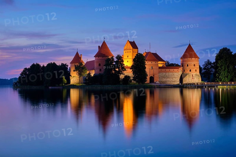 Night view of Trakai Island Castle in lake Galve illuminated in the evening, Lithuania, Europe