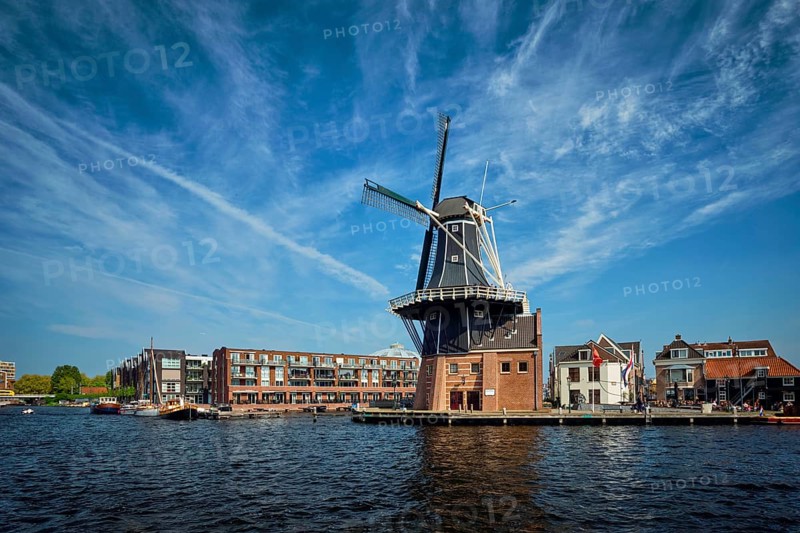 View of Harlem landmark windmill De Adriaan on Spaarne river. Harlem, Netherlands