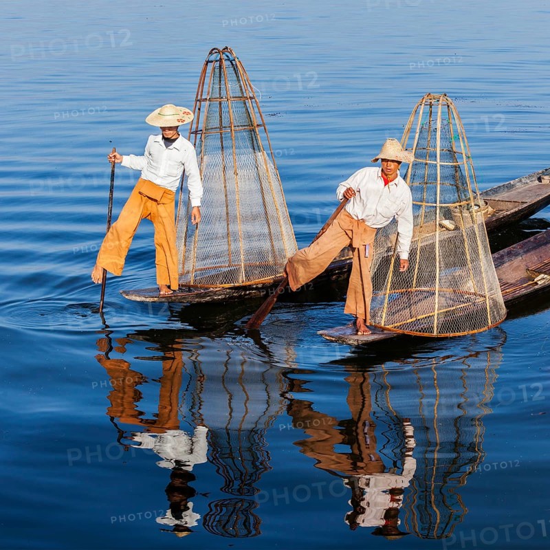 Myanmar travel attraction landmark, Traditional Burmese fishermen with fishing net at Inle lake in Myanmar famous for their distinctive one legged rowing style