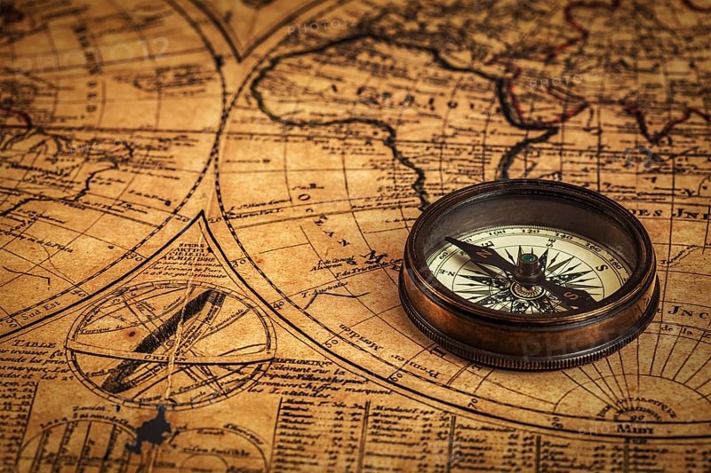 Travel geography navigation concept background, old vintage retro compass on ancient world map