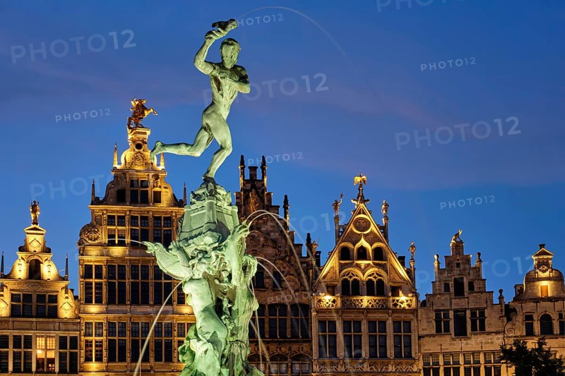Antwerp famous Brabo statue and fountain on Grote Markt square illuminated at night and old houses. Antwerp, Belgium, Europe