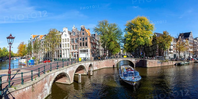 Canals and bridges building panorama at the Keizersgracht in the city of Amsterdam, Netherlands