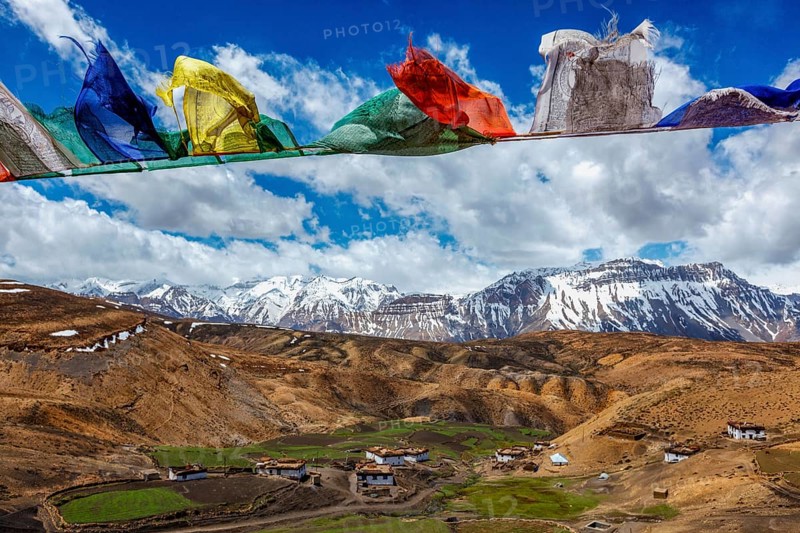 Buddhist prayer flags lungta with Om mani padme hum. . mantra written on them in sky over Comic Village. Spiti Valley, Himachal Pradesh, India, Asia