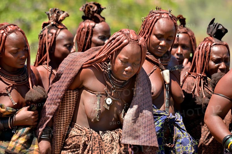 Mourning Himba women at a funeral, the widow in the middle, Omohanja, Kaokoland, Kunene, Namibia, Africa