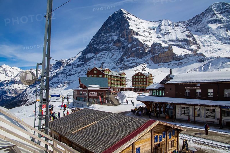25 March 2024, Kleine Scheidegg, Grindelwald Switzerland : Many skiers and tourists enjoy the sunny winter weather. The famous north face of the Eiger in the background