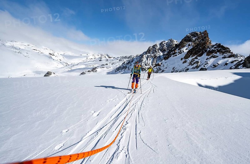 Ski tourer with rope, rope team on the Vadret da Porchabella glacier on the ascent to the summit of Piz Kesch, mountain landscape in winter, alpine tour, ski tour Bündner Haute Route, Albula Alps, Rhaetian Alps, Grisons, Eastern Switzerland, Switzerland, Europe