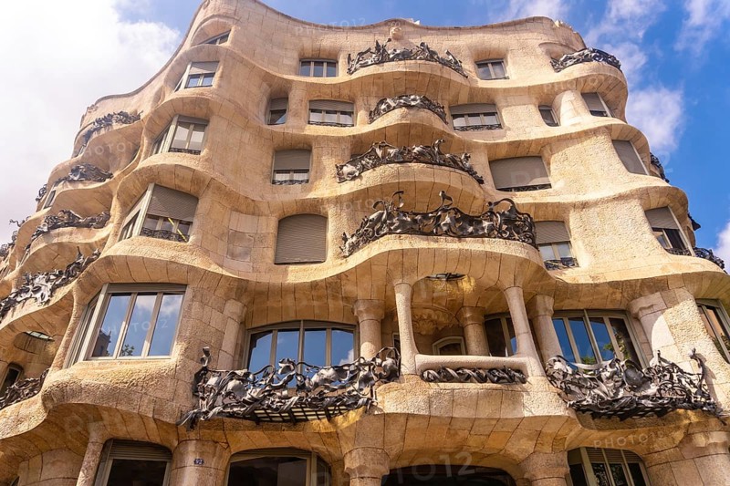 Wrought iron balconies and undulating facade of casa mila, a famous modernist building in barcelona, designed by antoni gaudi