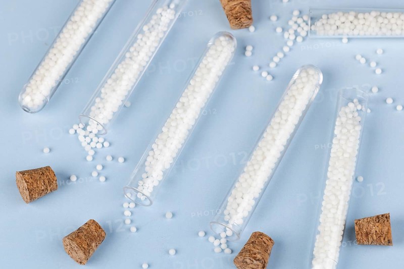 Test tubes with dropped globules and corks on a blue background
