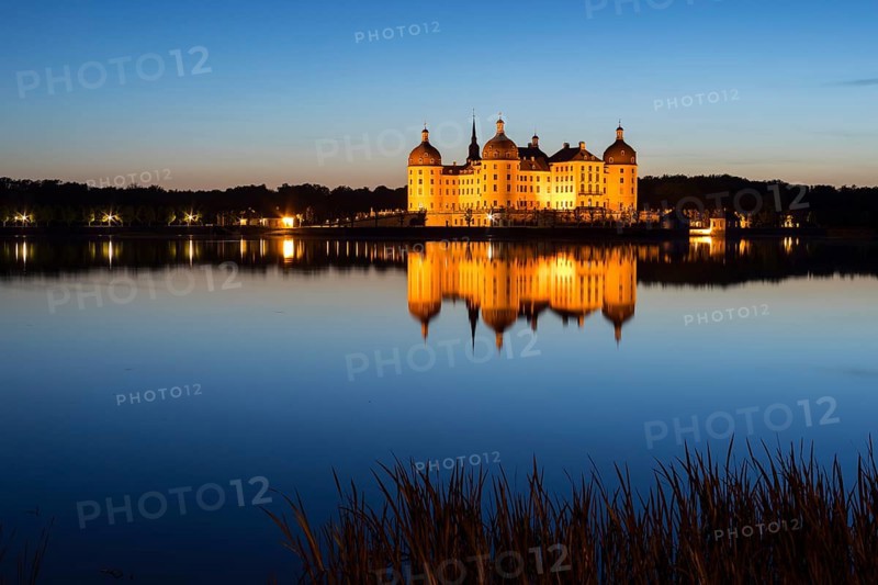 Castle with reflection in the castle pond in the evening, Moritzburg, Saxony, Germany, Europe