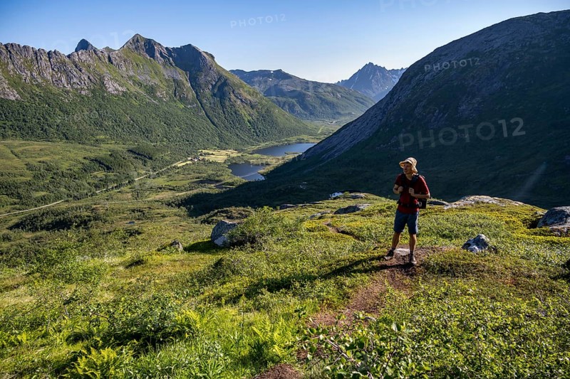 Mountaineers on a hiking trail to the summit of Rundfjellet, mountain landscape and valley with lakes, near Austnesfjord, Svolvaer, Nordland, Norway, Europe