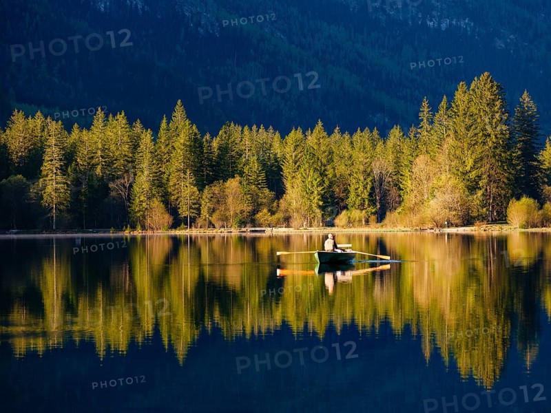 Angler in a rowing boat on the Hintersee in the first sunlight, Berchtesgaden National Park, Ramsau, Berchtesgadener Land, Upper Bavaria, Bavaria, Germany, Europe