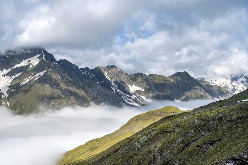 High fog in the valley, behind mountain peaks high above the clouds, Berliner Höhenweg, Zillertal Alps, Tyrol, Austria, Europe