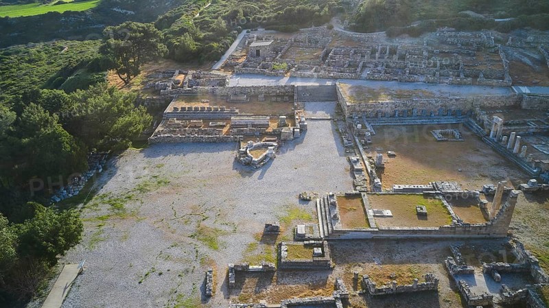 Drone shot, first morning light, backlight, Ancient ruins in an archaeological site, surrounded by nature and trees in daylight with mountains in the background, Kamiros, Archaeological site, Ancient city, Foundation of Doric Greeks, Rhodes, Dodecanese, Greek Islands, Greece, Europe