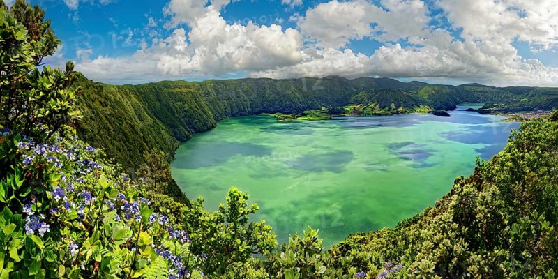 Breathtaking panoramic view of the crater lake Lagoa Azul surrounded by steep rock faces under a clear sky, crater circular hiking trail, Caldeira das Sete Cidades, Sete Cidades, Sao Miguel Island, Azores, Portugal, Europe
