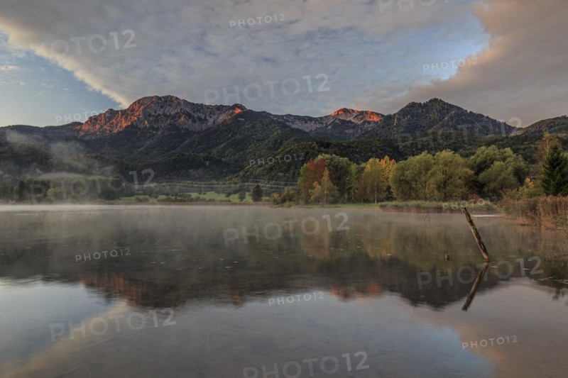 Mountains reflected in lake, morning light, autumn colours, clouds, Lake Kochel, Alpine foothills, Bavaria, Germany, Europe