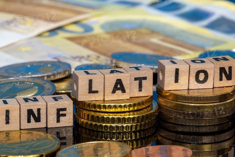 Symbolic image of inflation: euro coins and letters displaying the word INFLATION