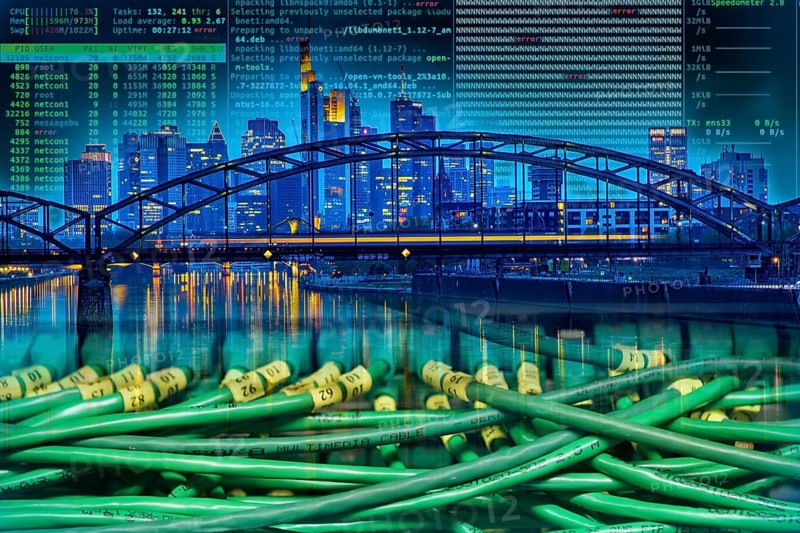Symbolic image of critical infrastructure, skyline of Frankfurt am Main, data cable, hacker code
