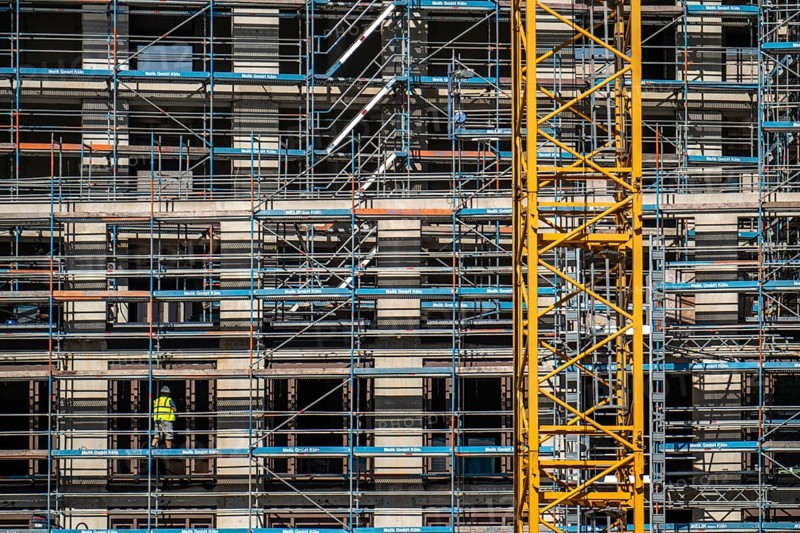 Construction site, at the Cologne Trade Fair Centre, new construction of a high-rise office building, construction cranes, facade of the shell, scaffolding, construction crane, North Rhine-Westphalia, Germany, Europe