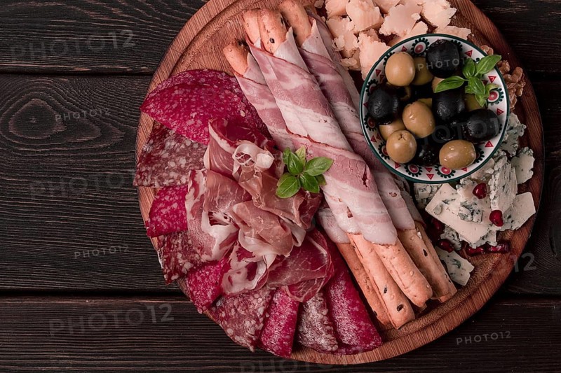 Appetizer, assortment, set, sausage, and cheese, on a wooden board, top view, no people