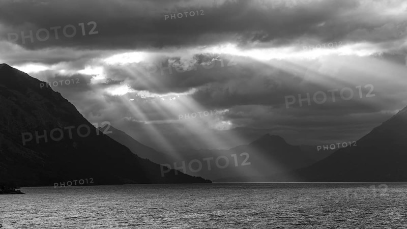 Black and white image of sunbeams and light mood at sunset at Lago Huechulafquen, Lanin National Park, Patagonia, Argentina, South America