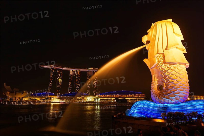 SINGAPORE, JANUARY 1, 2014: Night view of Singapore Merlion at Marina Bay and Marina Bay Sand complex. Merlion is a well-known tourist icon, mascot and national personification of Singapore