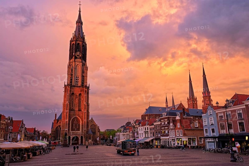 Delft, Netherlands, May 12, 2017: Nieuwe Kerk New Church protestant church on Delft Market Square Markt with dramatic sky on sunset. Delft, Netherlands