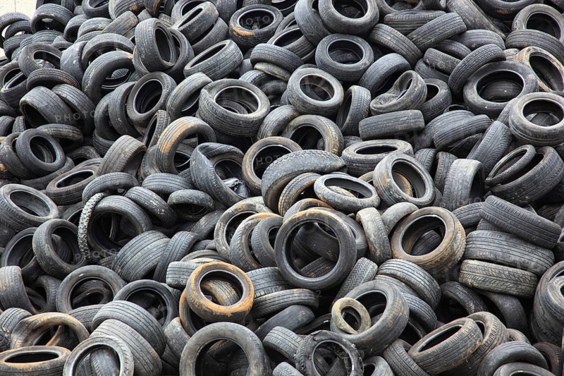 Old car tyres lie on stockpiles for recycling