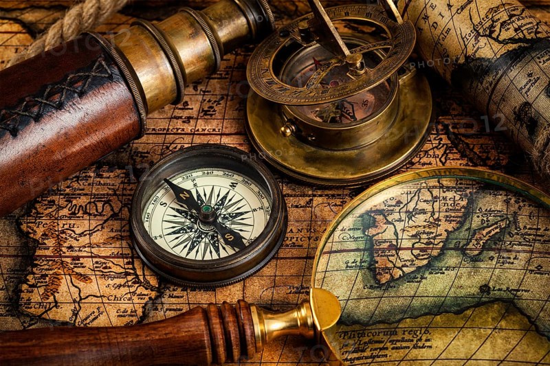 Travel geography navigation concept background, old vintage retro compass, sundial, magnifying glass and spyglass on ancient world map