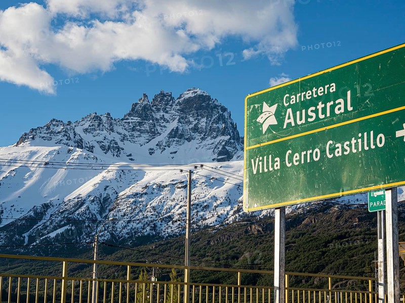 Signpost on road Carretera Austral at Villa Cerro Castillo, snowcapped Mt .Cerro Castillo, Patagonia, Chile, South America