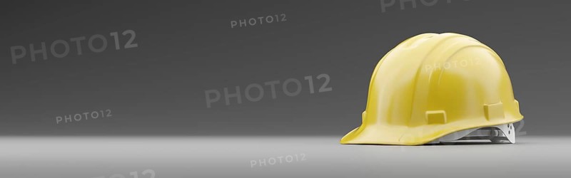 Yellow safety hard hat on a gradated background banner with room for text or graphics